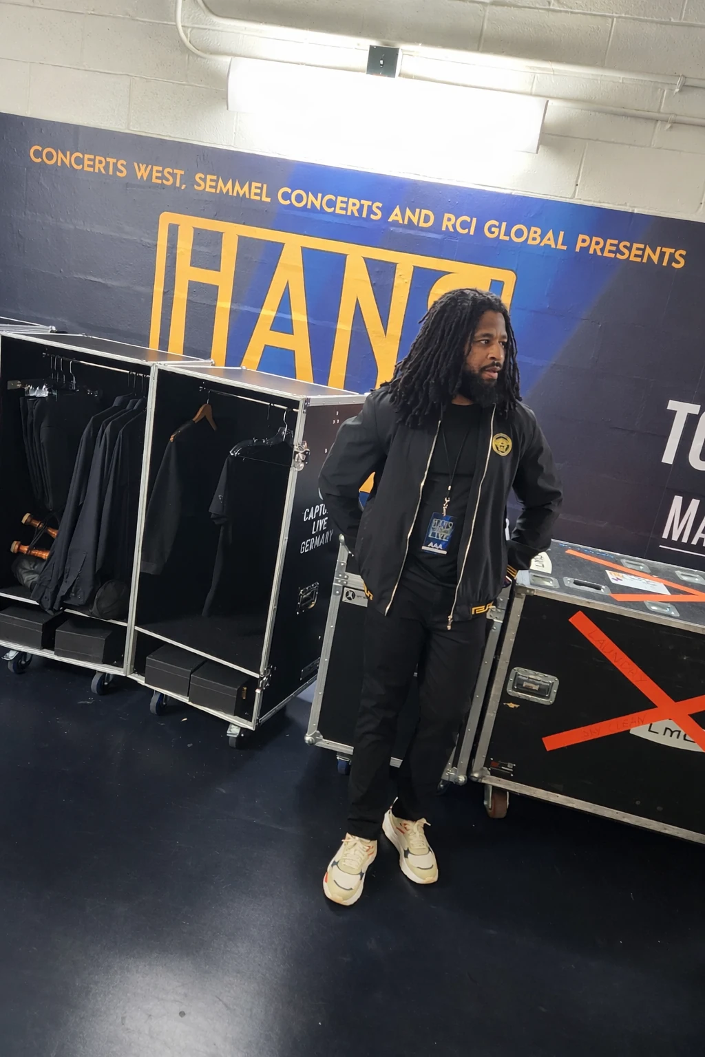 Sherman backstage beside touring equipment