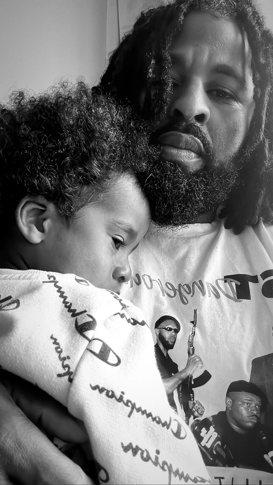 Sherman holding his sleeping child