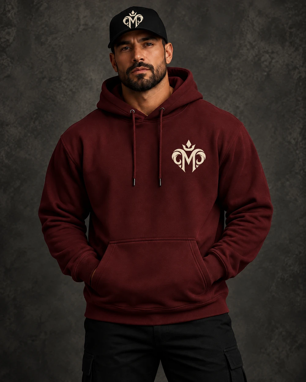 Model wearing the approved crowned M on the oxblood hoodie and cap
