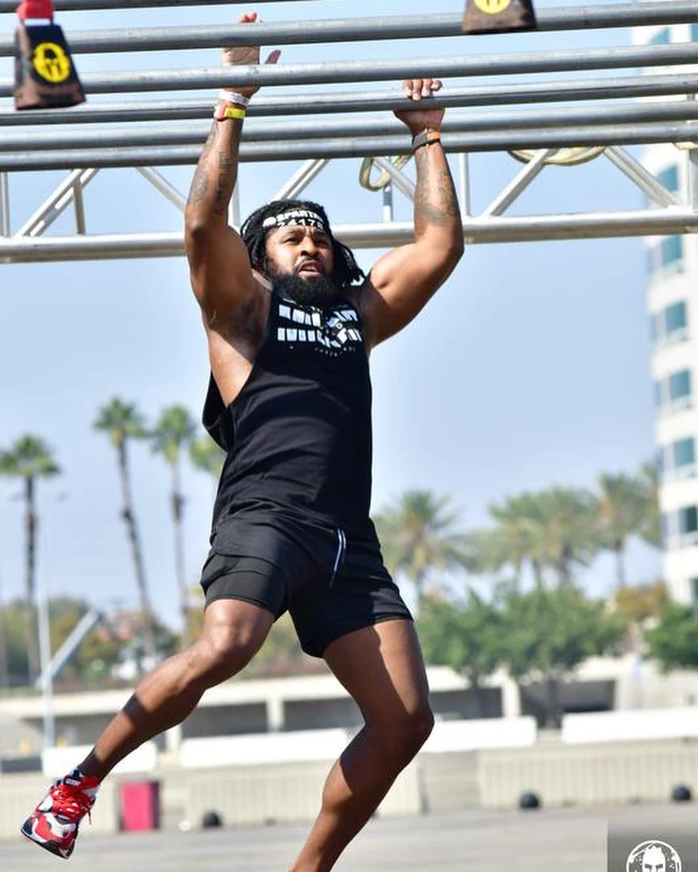 Sherman completing an overhead obstacle at a Spartan race